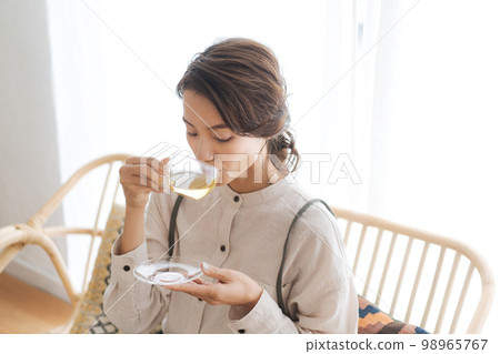 一個女人喝一杯熱飲料 一個女人喝一杯熱飲料 98965767