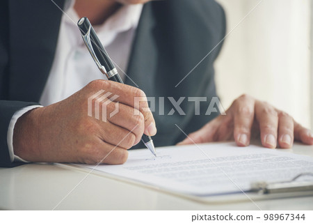 Asian business man using pen signing on new contract to starting projects in conference room. Close up manager businessman hands sign contract working meeting. Business agreement concepts. 98967344