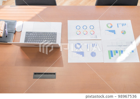 Notebooks and meeting materials placed in a lighted meeting room Notebooks and meeting materials placed in a lighted meeting room 98967536