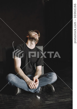 Bad habits problem. Drug addicted man took in dose. He is sitting alone satisfied. 98968166