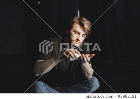 Depressed man suffering from suicidal depression. Want to commit suicide by taking strong medicament drugs and pills 98968181