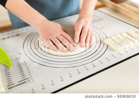 Kitchen silicone baking mat on the home kitchen table in the process of cooking 98968630