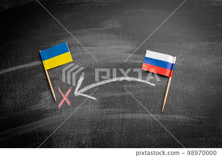Russian aggression against Ukraine concept. Flags on a dark chalkboard Russian aggression against Ukraine concept. Flags on a dark chalkboard 98970000