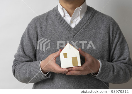 A man with a house model 98970211