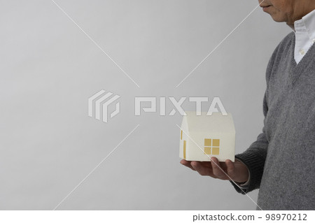 A man with a house model 98970212