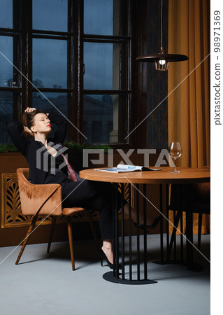 Satisfied woman read her article in magazine 98971369