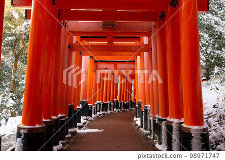 Kyoto, Japan - January 24 2023 : Fushimi Inari-taisha Torii Gates with snow on the roof in winter. 98971747
