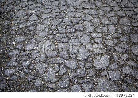 Cracked asphalt floor Cracked asphalt floor 98972224