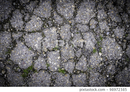 Cracked asphalt floor 98972385