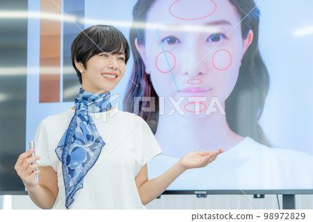 A female lecturer giving a makeup lesson in front of a monitor job hunting makeup business seminar 98972829