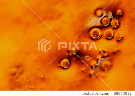 Melted red-gold bubbles like caramel brûlée shine with a heavy amber color (retouched image) Melted red-gold bubbles like caramel brûlée shine with a heavy amber color (retouched image) 98973081