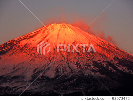 Red Mt.Fuji with snow smoke glowing red in the morning sun 98973473