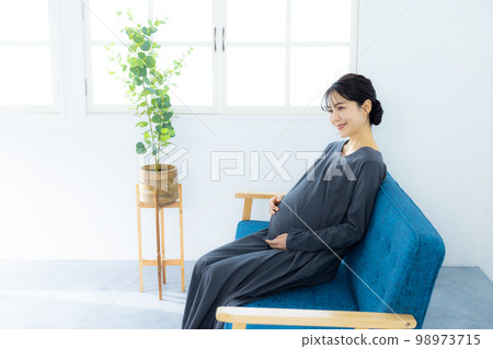 Pregnant woman living room Pregnant woman living room 98973715