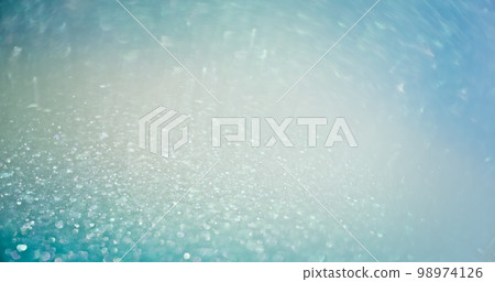 Light flare overlay. Bokeh glow. Glamour sequin gleam. Defocused blue color shimmering sparkles reflection abstract empty space background. Light flare overlay. Bokeh glow. Glamour sequin gleam. Defocused blue color shimmering sparkles reflection abstract empty space background. 98974126