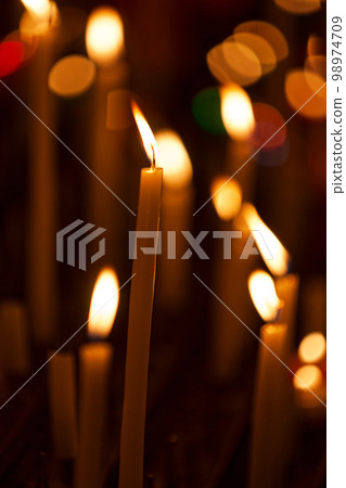Prayer candles in a church 98974709