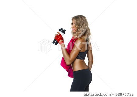Back view of sport girl with towel on neck drinking water from sport bottle on white background Back view of sport girl with towel on neck drinking water from sport bottle on white background 98975752