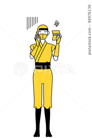 A woman dressed as a ninja who is depressed looking at her bankbook 98976136