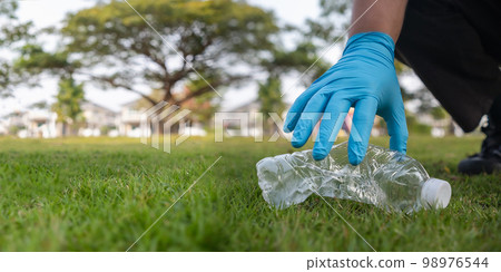 Volunteer man collecting trash and reusing plastic cleanup to recycle Volunteer man collecting trash and reusing plastic cleanup to recycle 98976544