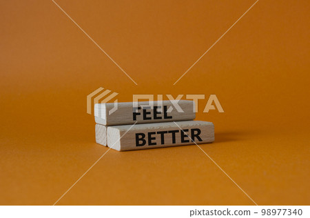 Feel better symbol. Wooden blocks with words Feel better. Beautiful orange background. Business and Feel better concept. Copy space. 98977340