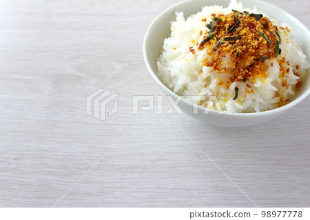 Egg furikake sprinkled over rice served in a bowl 98977778