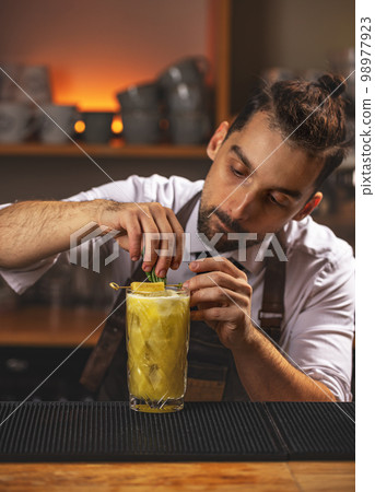 Barman decorated smoothie drink Barman decorated smoothie drink 98977923