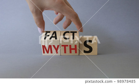 Facts vs Myths symbol. Businessman Hand turns cubes and changes word Myths to Facts. Beautiful grey background. Business and Facts vs Myths concept. Copy space 98978485