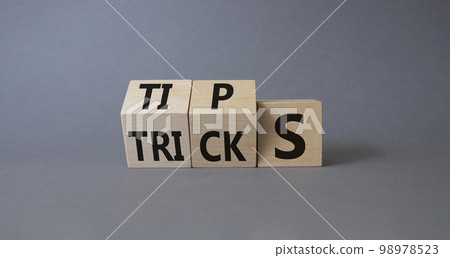 Tips and Tricks symbol. Wooden cubes with words Tricks and Tips. Beautiful grey background. Business and Tips and Tricks concept. Copy space Tips and Tricks symbol. Wooden cubes with words Tricks and Tips. Beautiful grey background. Business and Tips and Tricks concept. Copy space 98978523