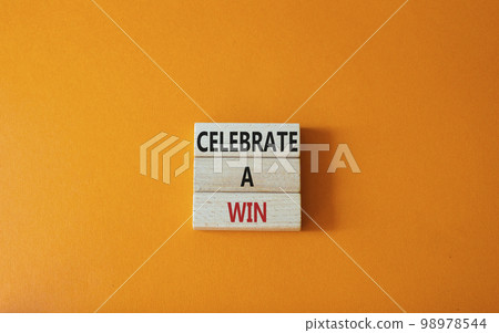 Celebrate a win symbol. Concept words Celebrate a win on wooden blocks. Beautiful orange background. Business and Celebrate a win concept. Copy space. Celebrate a win symbol. Concept words Celebrate a win on wooden blocks. Beautiful orange background. Business and Celebrate a win concept. Copy space. 98978544