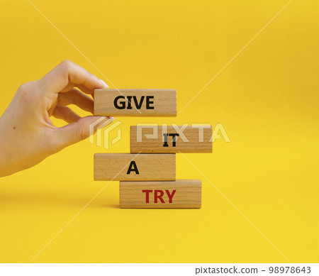 Give it a try symbol. Concept words Give it a try on wooden blocks. Beautiful yellow background. Businessman hand. Business and Give it a try concept. Copy space. Give it a try symbol. Concept words Give it a try on wooden blocks. Beautiful yellow background. Businessman hand. Business and Give it a try concept. Copy space. 98978643