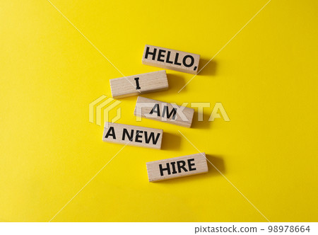 Hello I am a new hire symbol. Concept words Hello I am a new hire on wooden blocks. Beautiful yellow background. Business and Hello I am a new hire concept. Copy space. 98978664
