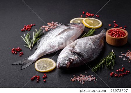 Fresh raw dorado fish with spices, herbs, salt and lemon 98978797