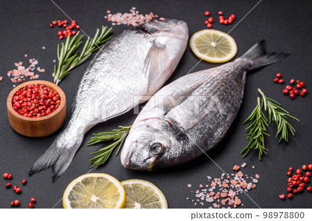 Fresh raw dorado fish with spices, herbs, salt and lemon 98978800