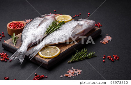 Fresh raw dorado fish with spices, herbs, salt and lemon 98978810