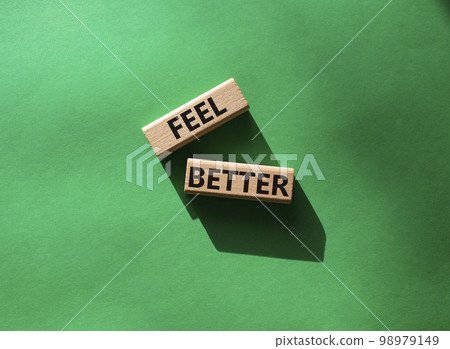 Feel better symbol. Wooden blocks with words Feel better. Beautiful green background. Business and Feel better concept. Copy space. 98979149