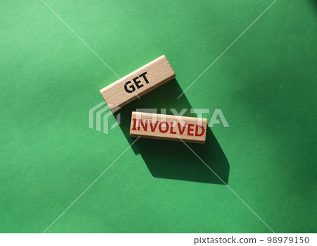 Get involved symbol. Wooden blocks with words Get involved. Beautiful green background. Business and Get involved concept. Copy space. 98979150