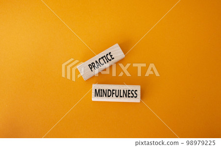Practice Mindfulness symbol. Concept words Practice Mindfulness on wooden blocks. Beautiful orange background. Medical and Psychology and Practice Mindfulness concept. Copy space. 98979225