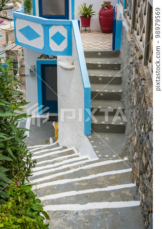 Steep and narrow alleys in Olymbos village Steep and narrow alleys in Olymbos village 98979569