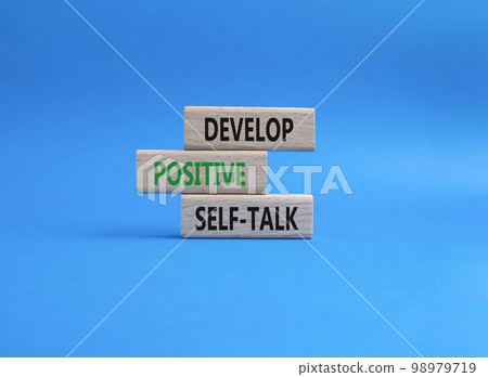 Develop positive self-talk symbol. Concept words Develop positive self-talk on wooden blocks. Beautiful blue background. Business and Develop positive self-talk concept. Copy space 98979719
