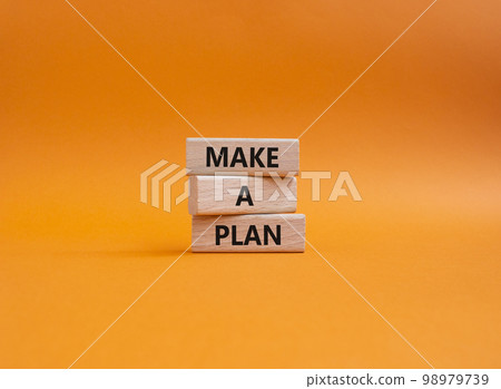 Make a plan symbol. Concept word Make a plan on wooden blocks. Beautiful orange background. Business and Make a plan concept. Copy space 98979739