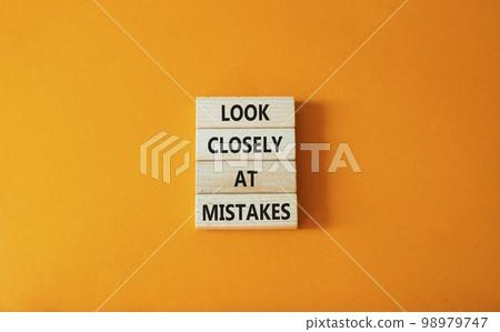 Look closely at mistakes symbol. Wooden blocks with words Look closely at mistakes. Beautiful orange background. Business and Look closely at mistakes concept. Copy space. 98979747