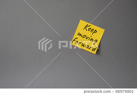 Keep moving forward symbol. Concept words keep moving forward on orange steaky note. Beautiful grey background. Business and keep moving forward concept. Copy space. Keep moving forward symbol. Concept words keep moving forward on orange steaky note. Beautiful grey background. Business and keep moving forward concept. Copy space. 98979802
