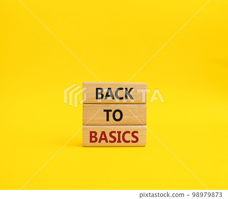 Back to basics symbol. Concept word Back to basics on wooden blocks. Beautiful yellow background. Business and Back to basics concept. Copy space Back to basics symbol. Concept word Back to basics on wooden blocks. Beautiful yellow background. Business and Back to basics concept. Copy space 98979873