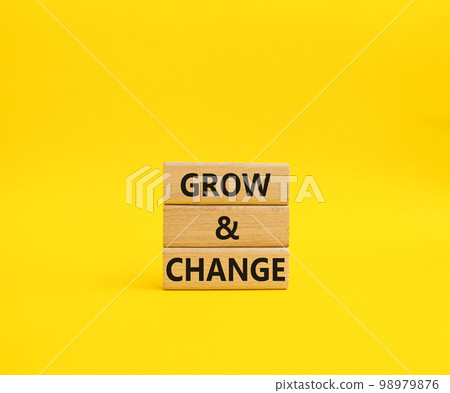 Grow and Change symbol. Concept word Grow and Change on wooden blocks. Beautiful yellow background. Business and Grow and Change concept. Copy space 98979876