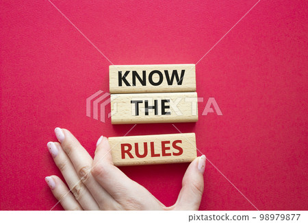 Know the rules symbol. Wooden blocks with words Know the rules. Beautiful red background. Businessman hand. Business and Know the rules concept. Copy space. Know the rules symbol. Wooden blocks with words Know the rules. Beautiful red background. Businessman hand. Business and Know the rules concept. Copy space. 98979877