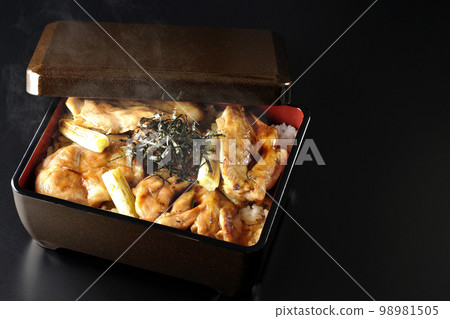 Hot charcoal-grilled yakitori with plenty of sauce, photographed against a black background Hot charcoal-grilled yakitori with plenty of sauce, photographed against a black background 98981505