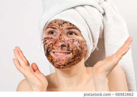 A woman does facial treatments, face natural scrub, looks up. 98981662