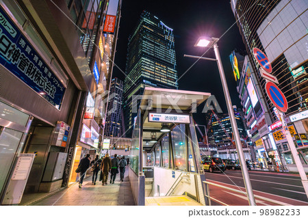The cityscape of Tokyo, Japan, overlooking Shibuya Station (entrance B3) at night. In the back is Shibuya Station on the Ginza Line and Shibuya Scramble Square The cityscape of Tokyo, Japan, overlooking Shibuya Station (entrance B3) at night. In the back is Shibuya Station on the Ginza Line and Shibuya Scramble Square 98982233