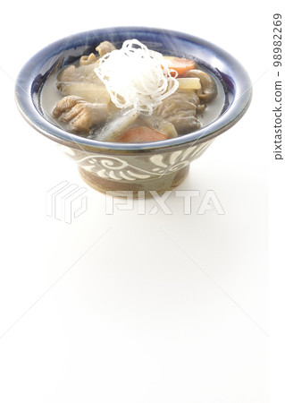 Hot pork offal stew with carrots, konjac, burdock and radish shot against a white background Hot pork offal stew with carrots, konjac, burdock and radish shot against a white background 98982269