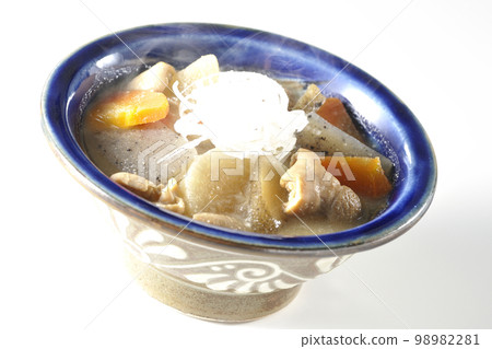 Hot pork offal stew with carrots, konjac, burdock and radish shot against a white background Hot pork offal stew with carrots, konjac, burdock and radish shot against a white background 98982281
