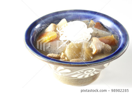 Hot pork offal stew with carrots, konjac, burdock and radish shot against a white background Hot pork offal stew with carrots, konjac, burdock and radish shot against a white background 98982285